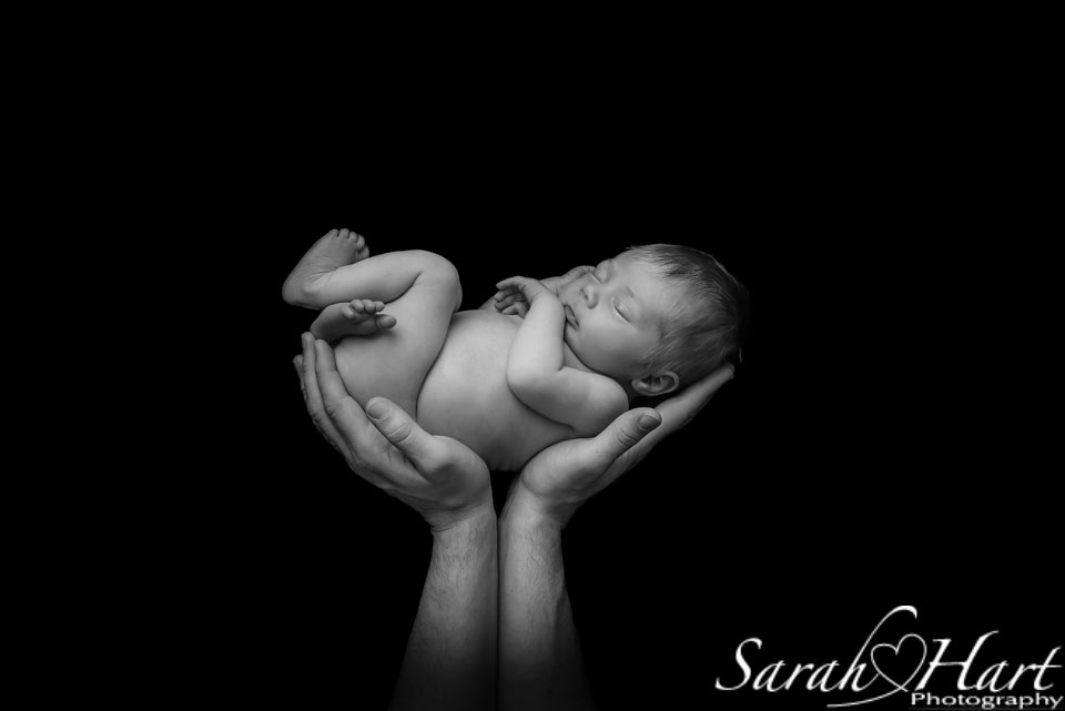 black and white image of baby in hands, Kent photography