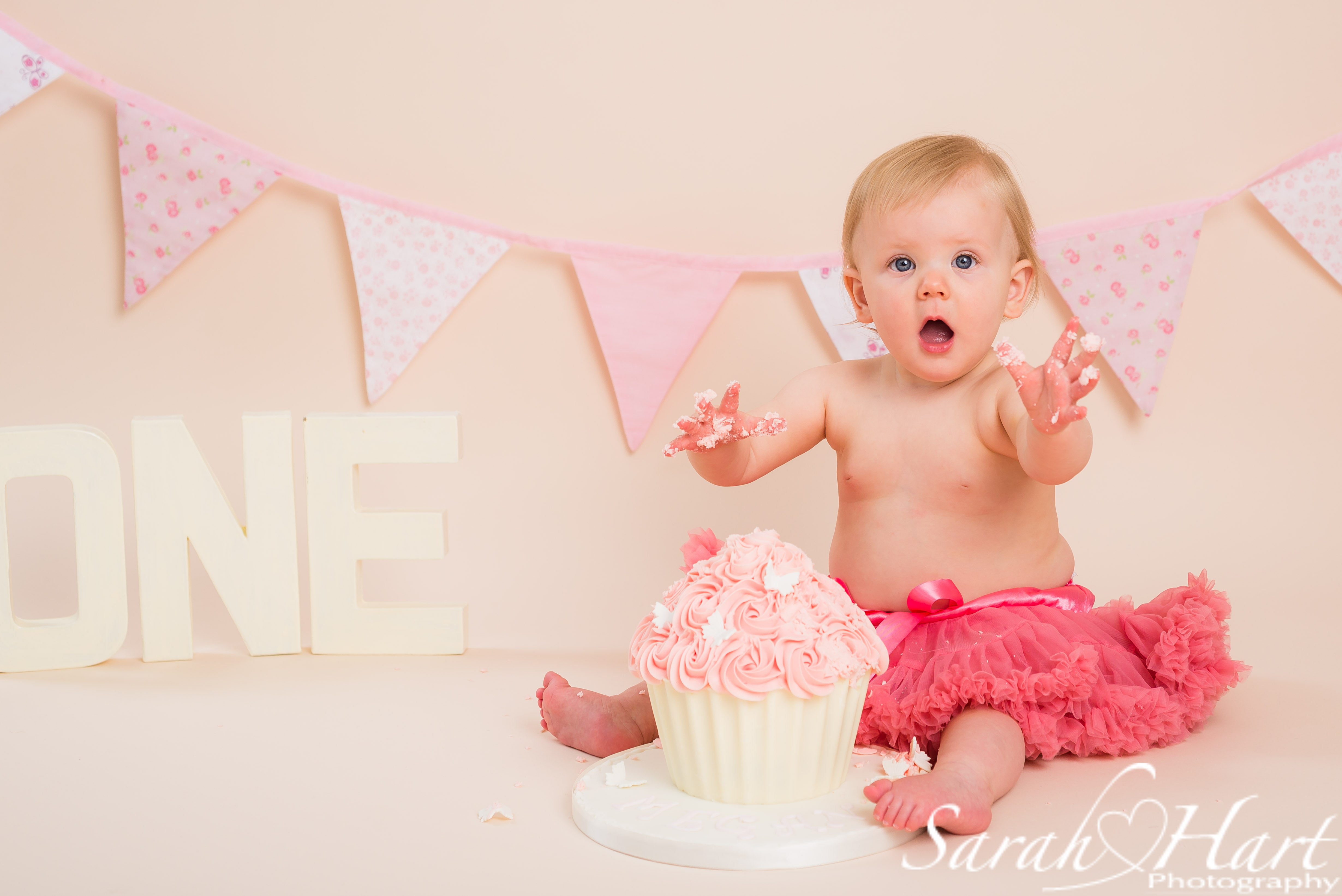 pink giant cupcake, buttercream mess, cake smash photography, Tunbridge Wells cake smash