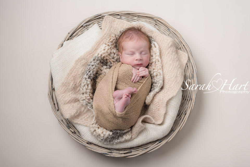 neutral tones with baby in a basket, best newborn photographer tonbridge
