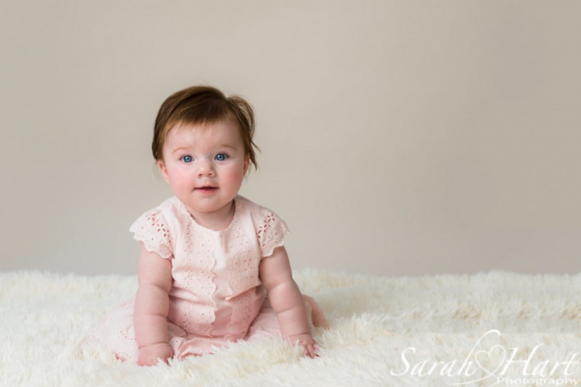 Sitting up unaided, gorgeous baby photo, neutral backdrop, baby blues, Sarah Hart image