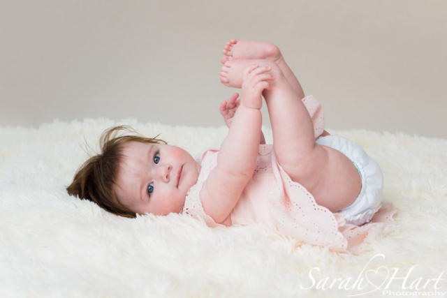 Baby holding feet, baby pictures, frilly pants, baby portrait