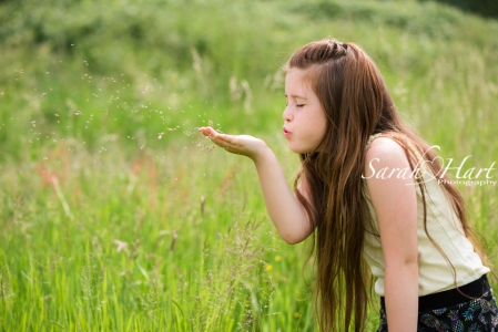 Blowing grass seeds, girl in meadow, Kent photographer, Sarah Hart Photography, Maidstone, Tonbridge