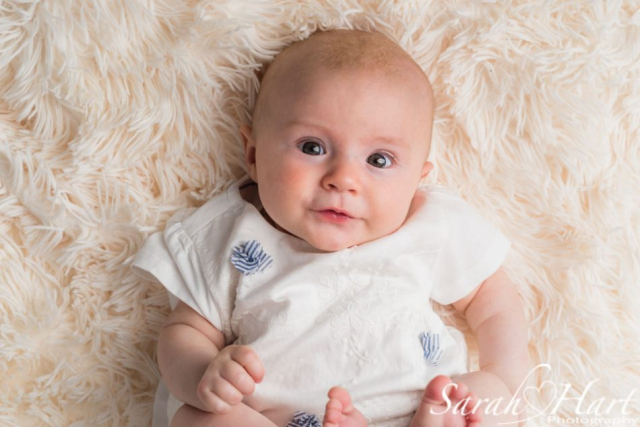 i'm looking at you, baby expressions, cream fur rug, baby photoshoot in kent