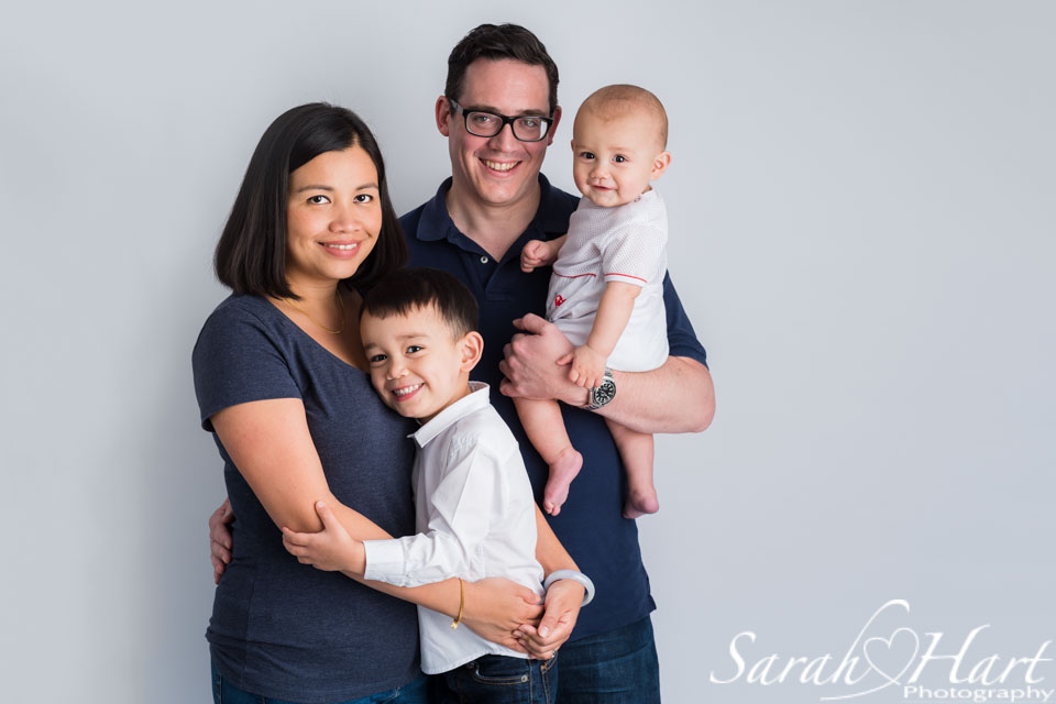 stunning family portrait and baby milestone session, white backdrop family image