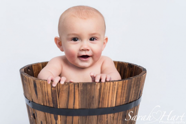 baby in a wooden bucket, funny baby pictures, baby photography in west kent and east sussex