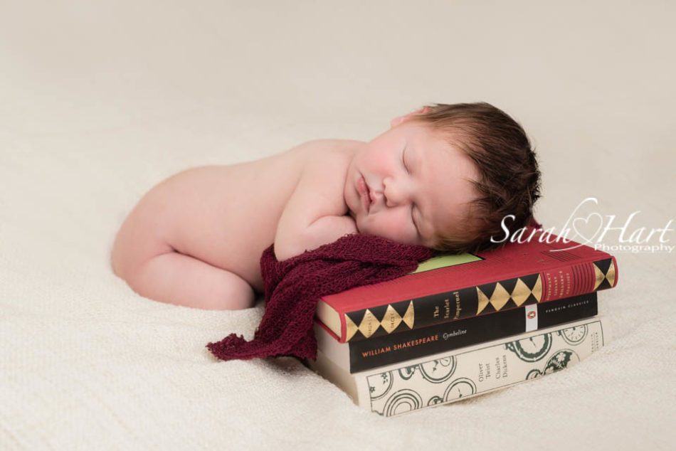 best kent baby photographer, newborn posed on books