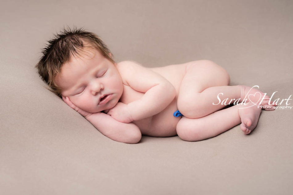 sleepy newborn on brown balnket, newborn baby photographer in kent