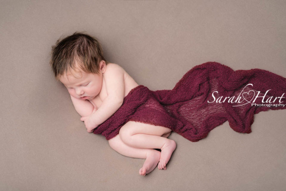 best newborn photographer in tonbridge, red and brwon colours for newborn baby