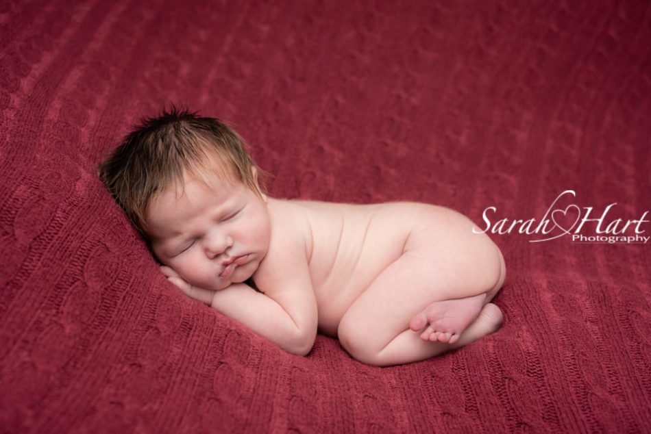 baby on red blanket, tunbridge wells newborn photographer
