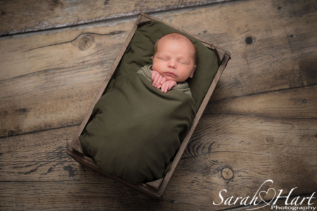 newborn in a crate, artistic newborn photography