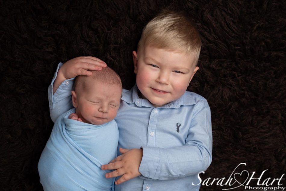 photographing your own newborn with their sibling, newborn photography kent