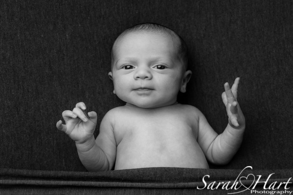 Black and white image of newborn wide awake, photographing your own newborn