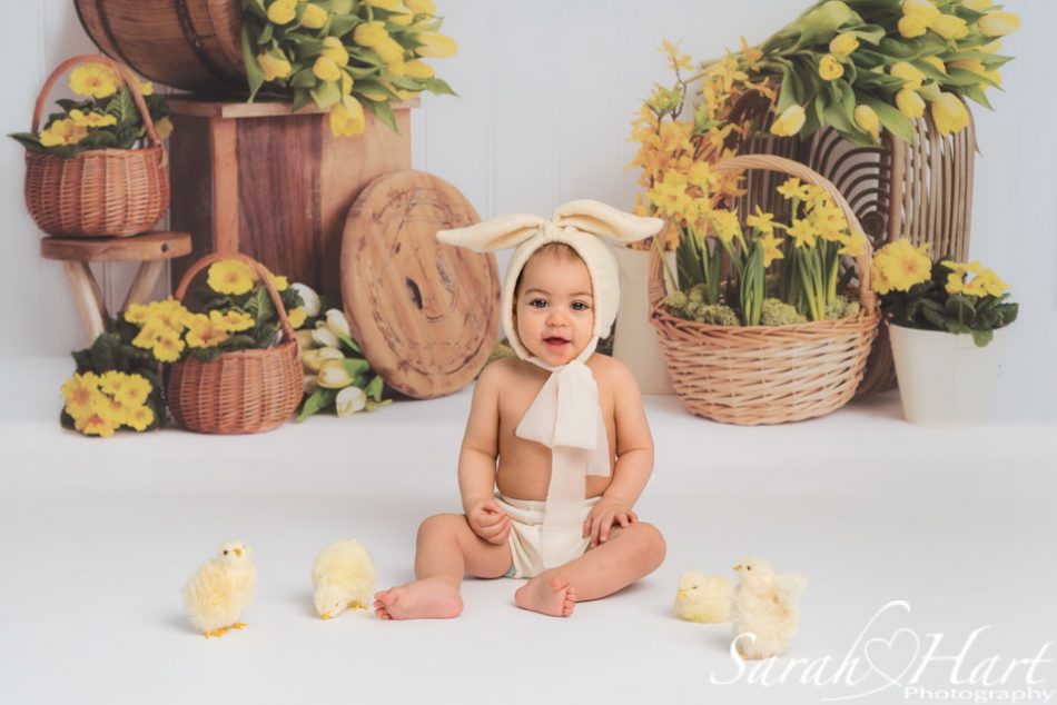 Little baby sat amongst chicks for a Spring themed photoshoot