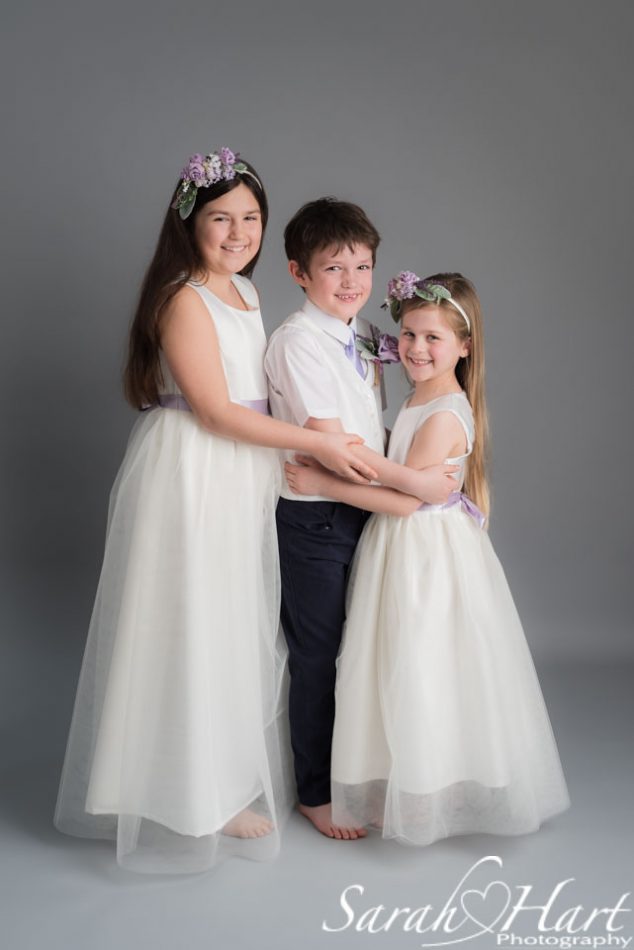 Trio of bridesmaid and paige boy outfits at occasion wear photoshoot