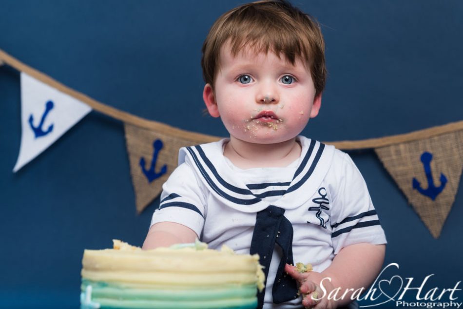 cake face of a little boy at his cake smash, kent