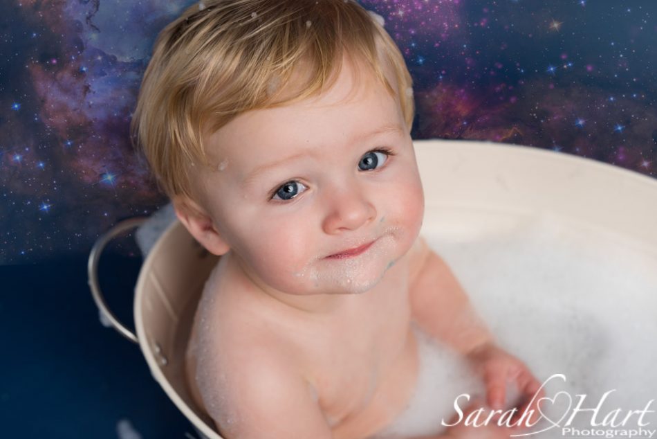 little boy at his space theme cake smash in the bath tub, Tonbridge, Kent
